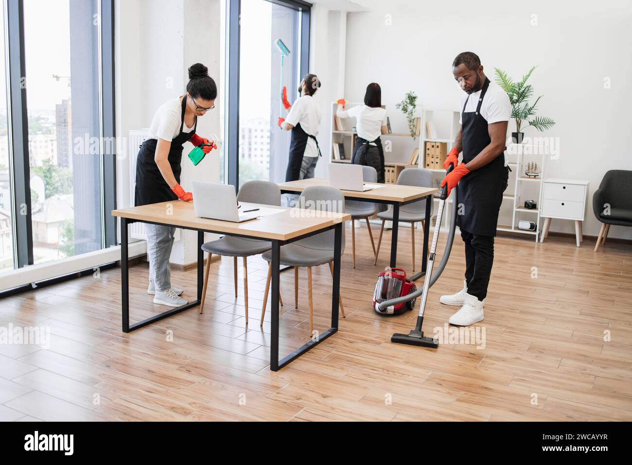 Team of young multicultural cleaners . Stock Photo