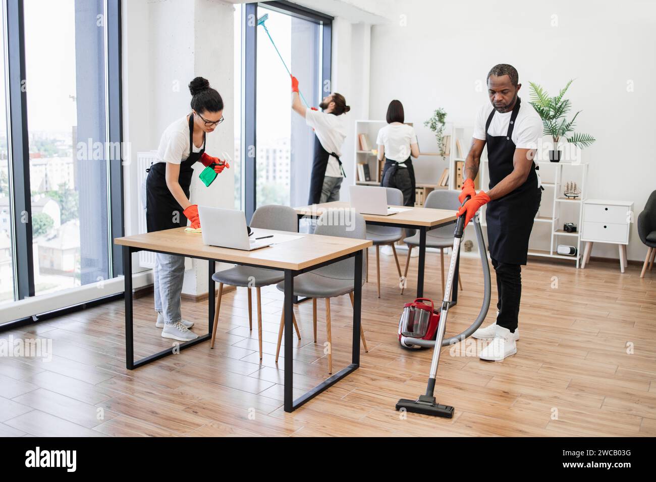 Team of young multicultural cleaners . Stock Photo