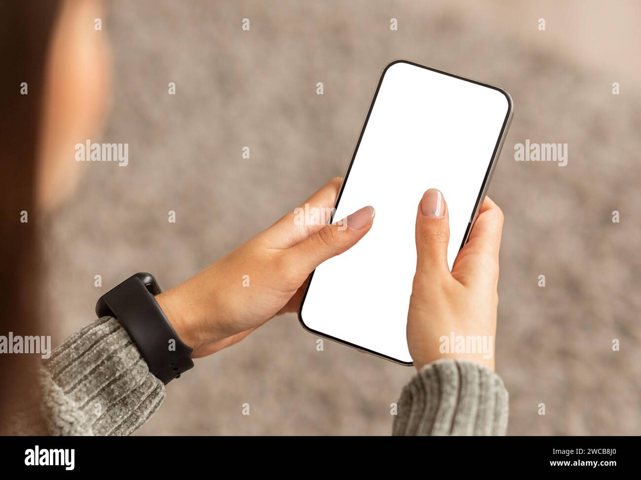 Unrecognizable young lady using smartphone with white screen Stock Photo