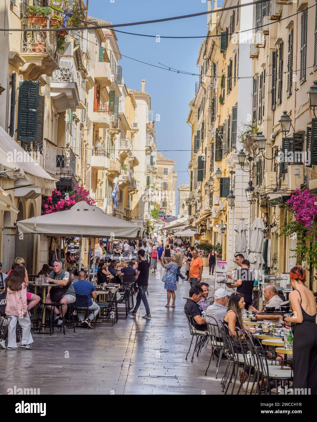 Busy traffic-free street lined with restaurants in elegant Corfu Town in the Greek Ionian Islands Stock Photo