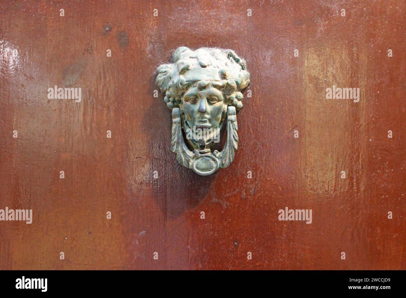 old wood door and metal knocker in rethymno in crete in greece Stock Photo