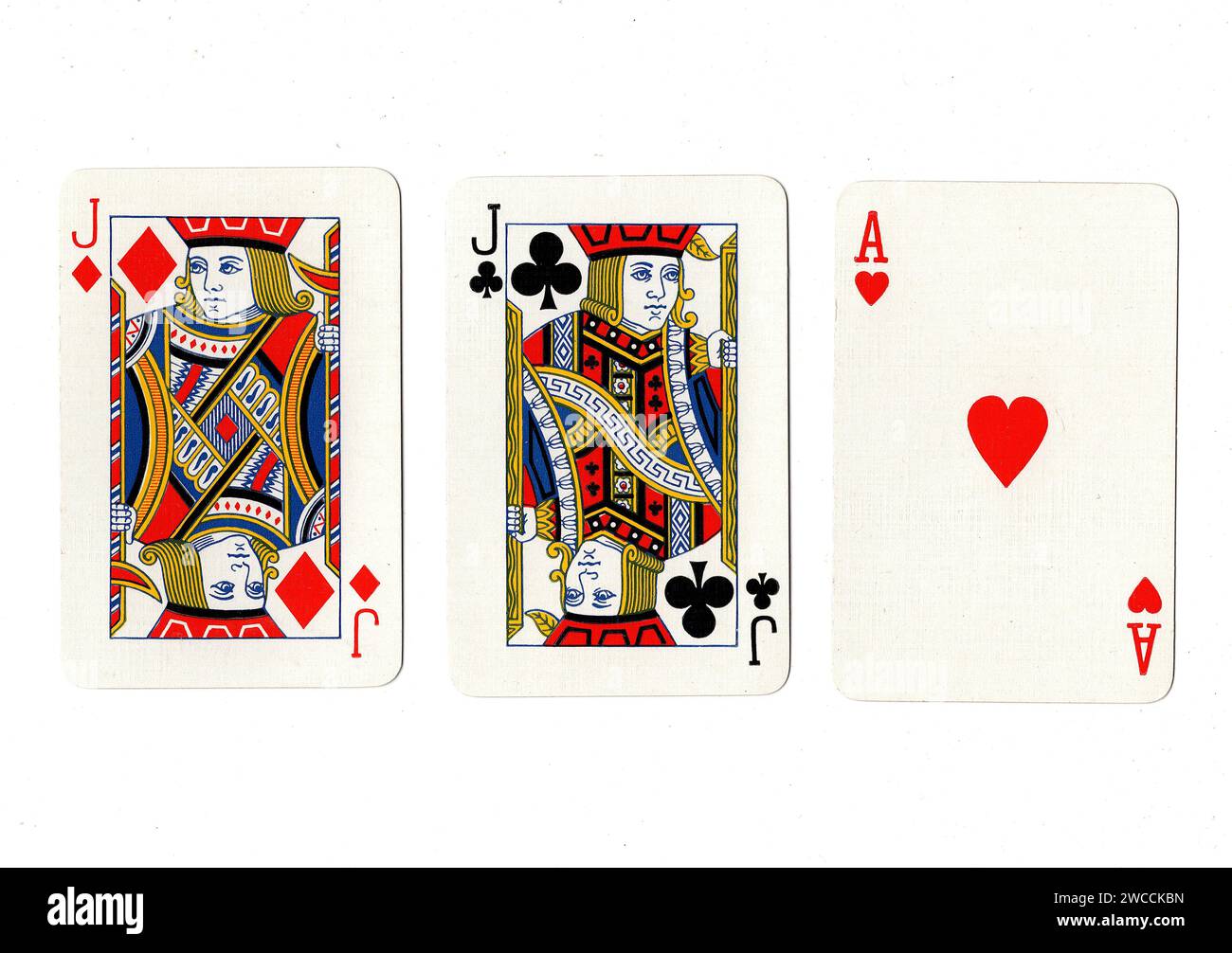 Vintage playing cards showing a pair of jacks and an ace isolated on a white background. Stock Photo