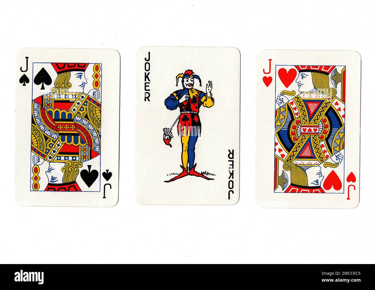 Vintage playing cards showing a pair of jacks and a joker isolated on a white background. Stock Photo
