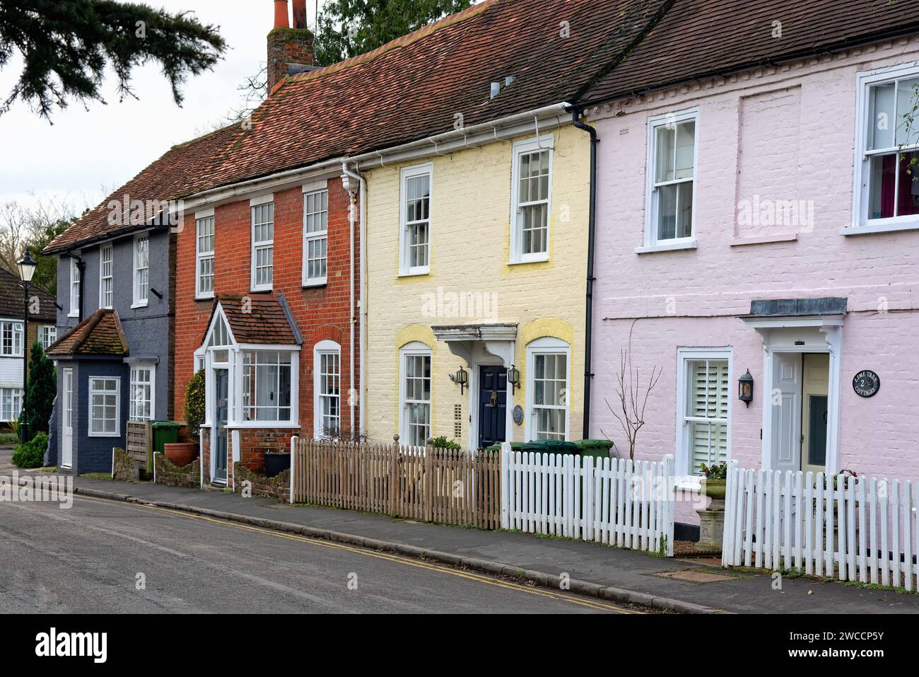 Exteriors of old and attractive terraced cottages painted in pastels colours in Church Road, old Shepperton Surrey England UK Stock Photo