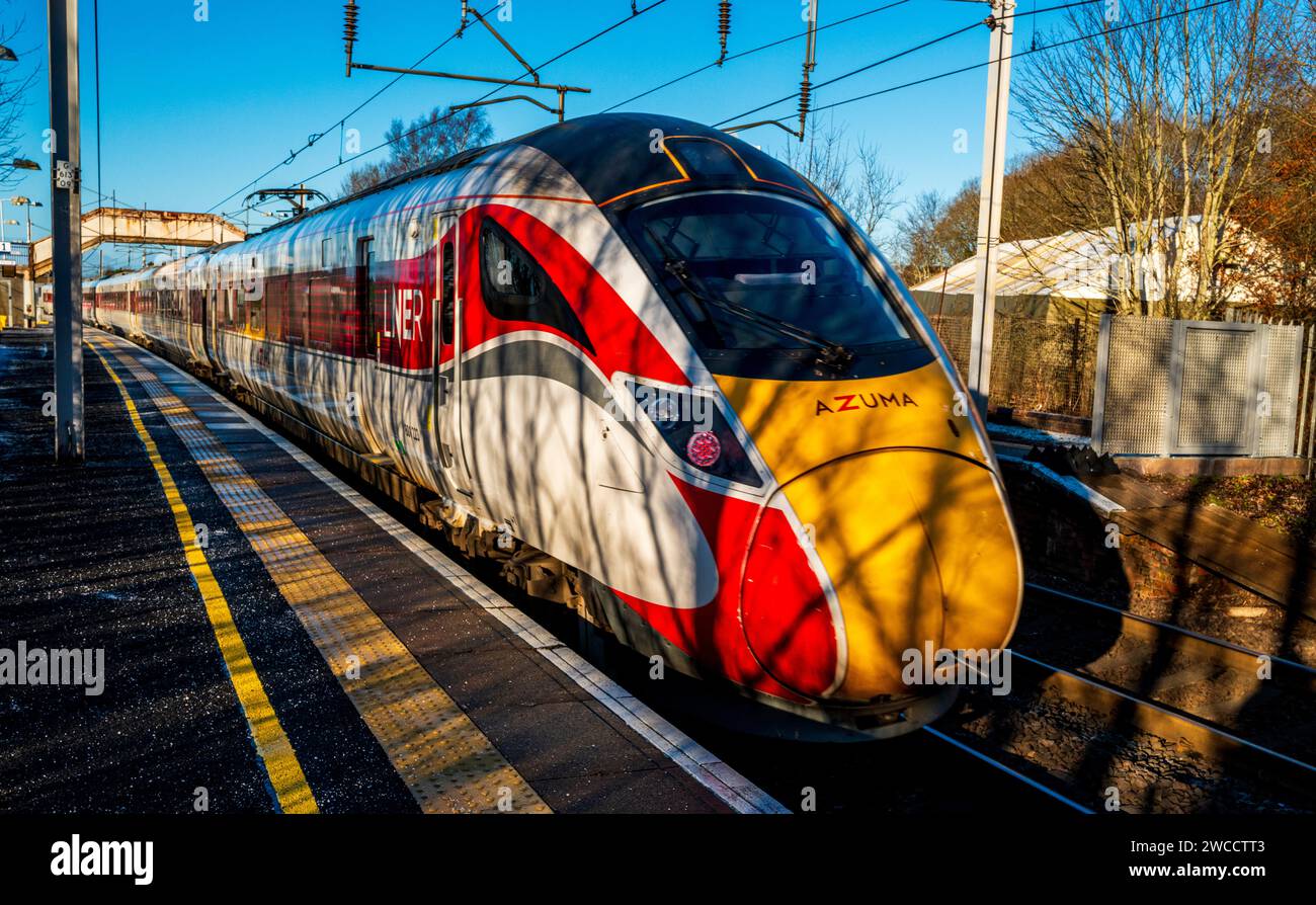 LNER Inter-City express passing through Carluke station, South Lanarkshire, Scotland at speed Stock Photo