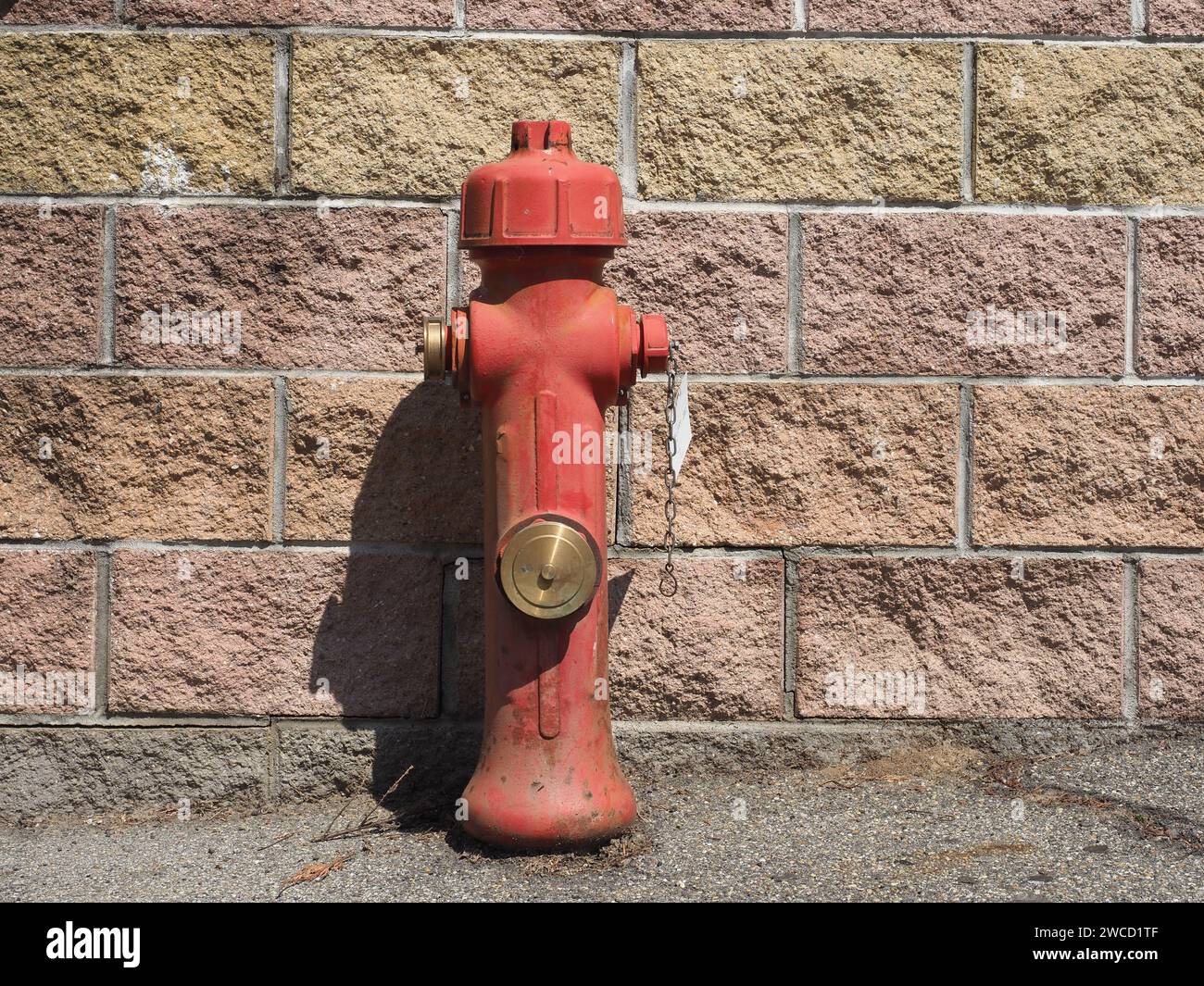 A Fire Hydrant In A Street In Front Of Stone Brick Wall With Copy Space ...