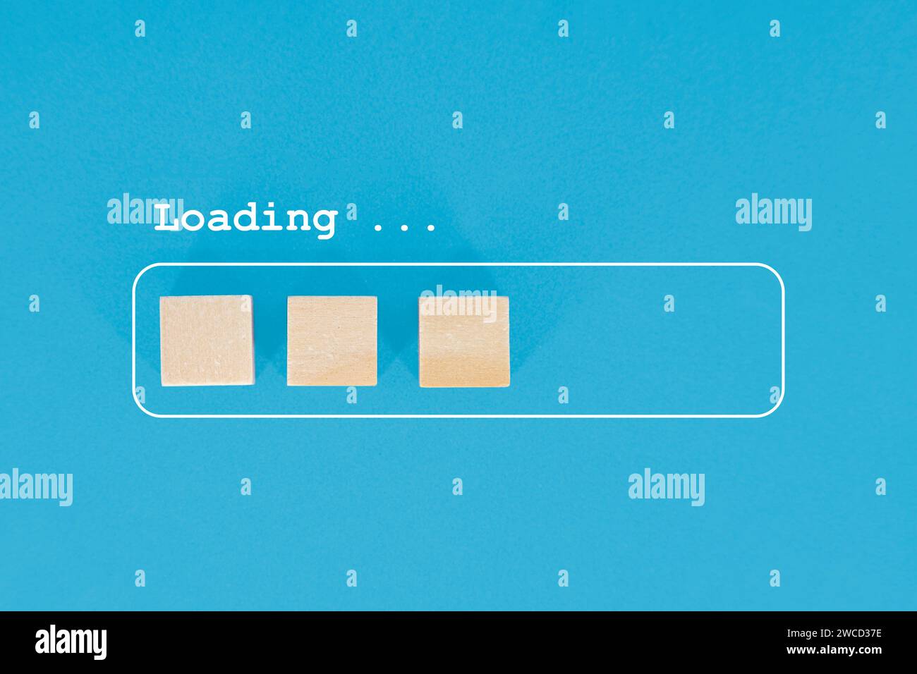 Minimalist visual metaphor of a loading progress bar depicted by wooden blocks on a blue background. Stock Photo