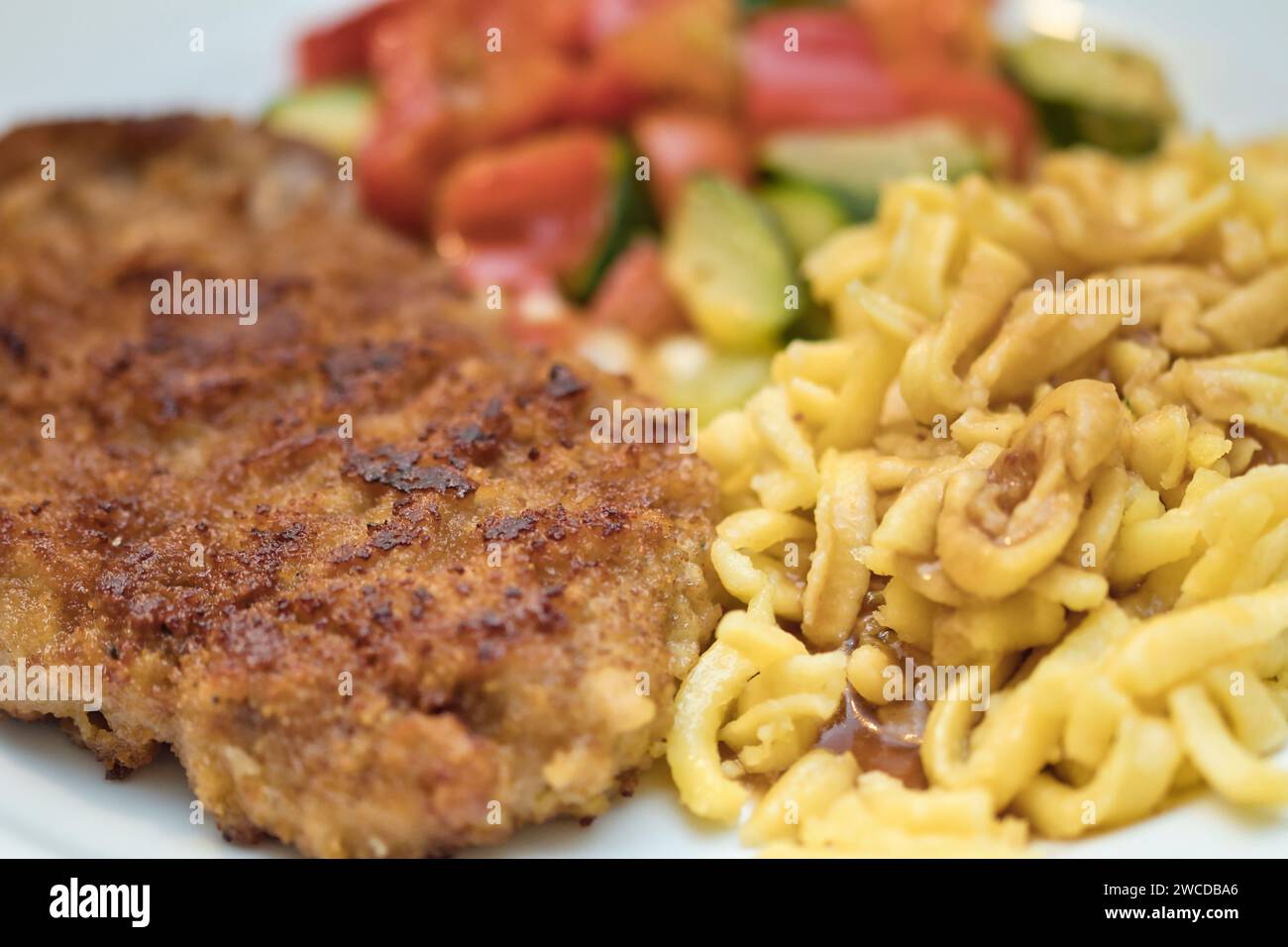 Schnitzel with spaetzle and vegetables Stock Photo