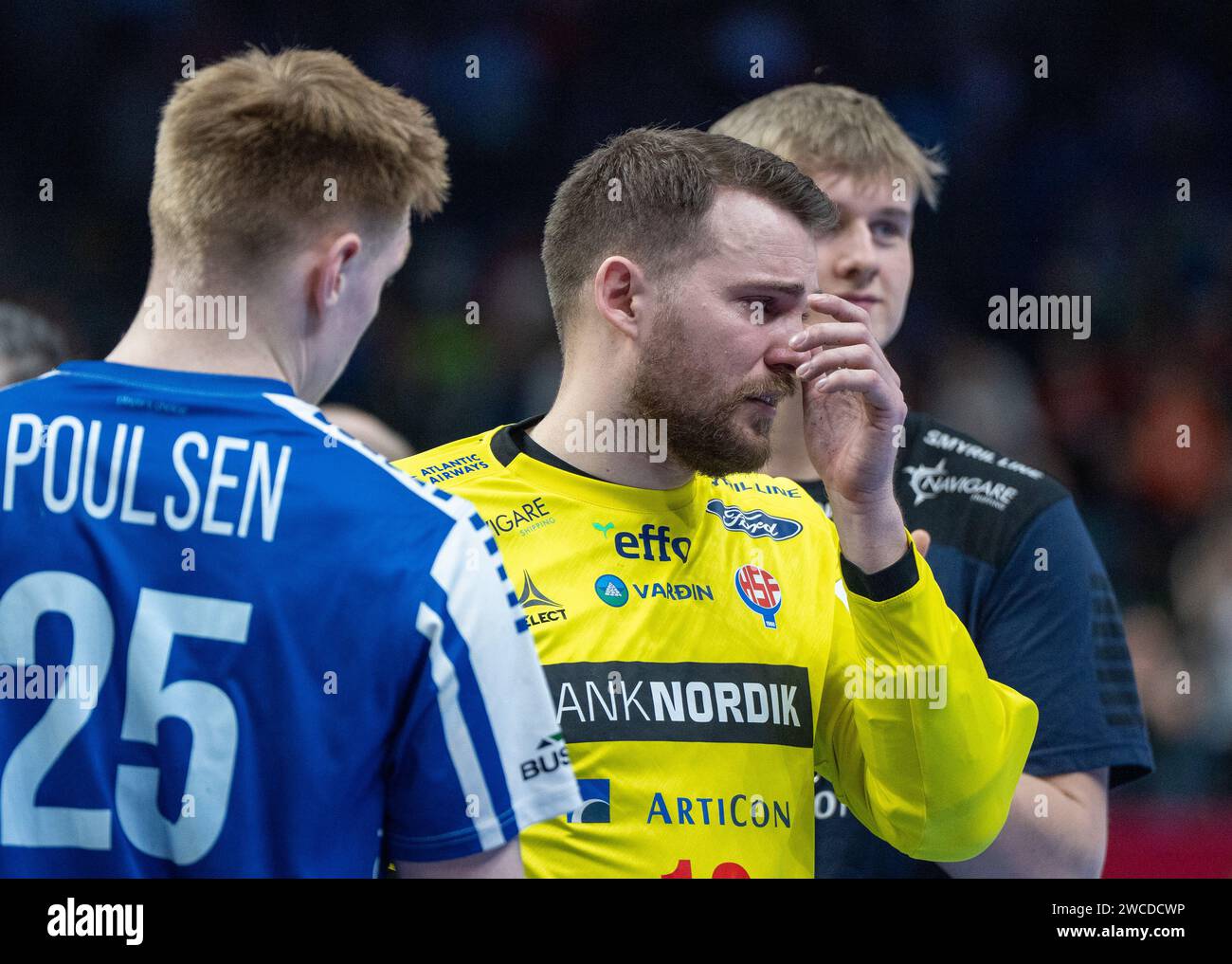 Berlin, Germany. 15th Jan, 2024. Handball: European Championship, Poland - Faroe Islands, preliminary round, Group D, match day 3, goalkeeper Nicholas Satchwell (M) from the Faroe Islands is comforted after the match. Credit: Soeren Stache/dpa/Alamy Live News Stock Photo