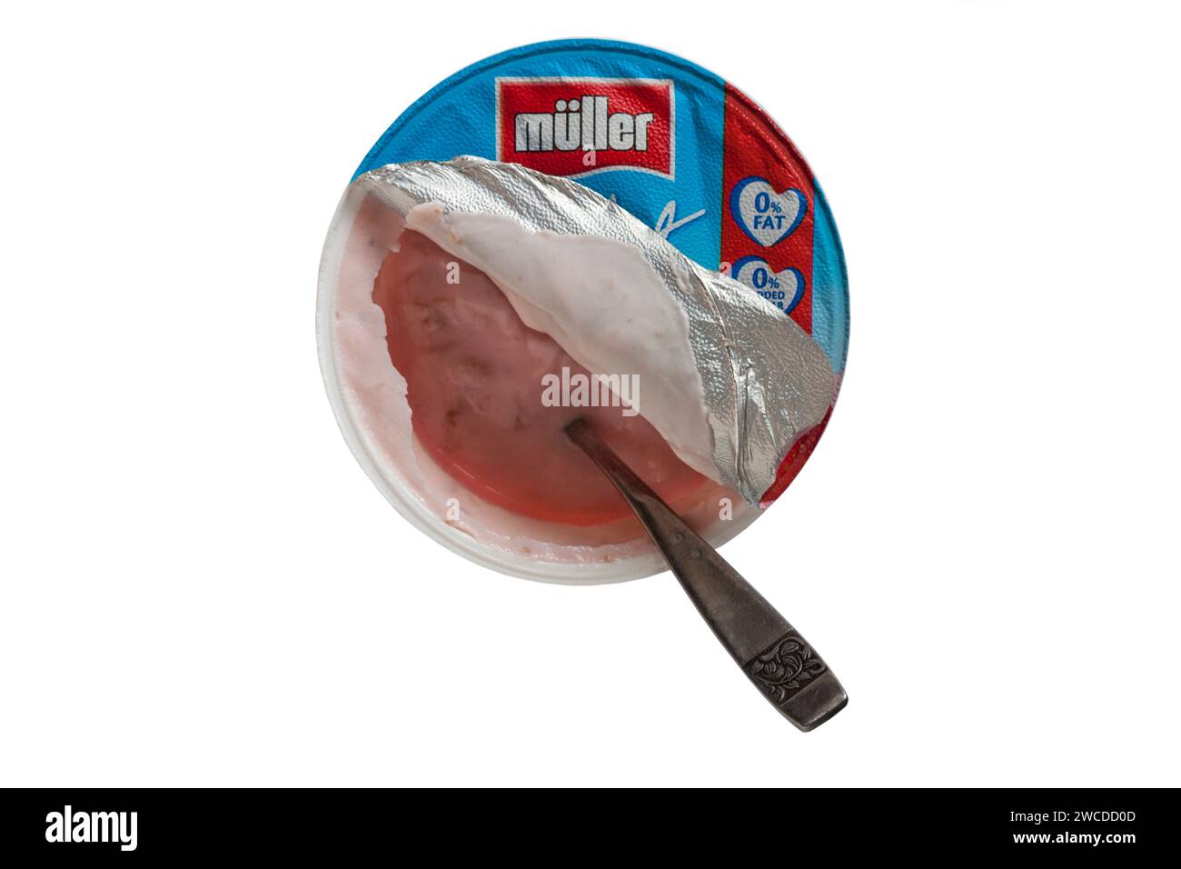 pot of Muller light strawberry fat free yogurt opened with spoon in isolated on white background