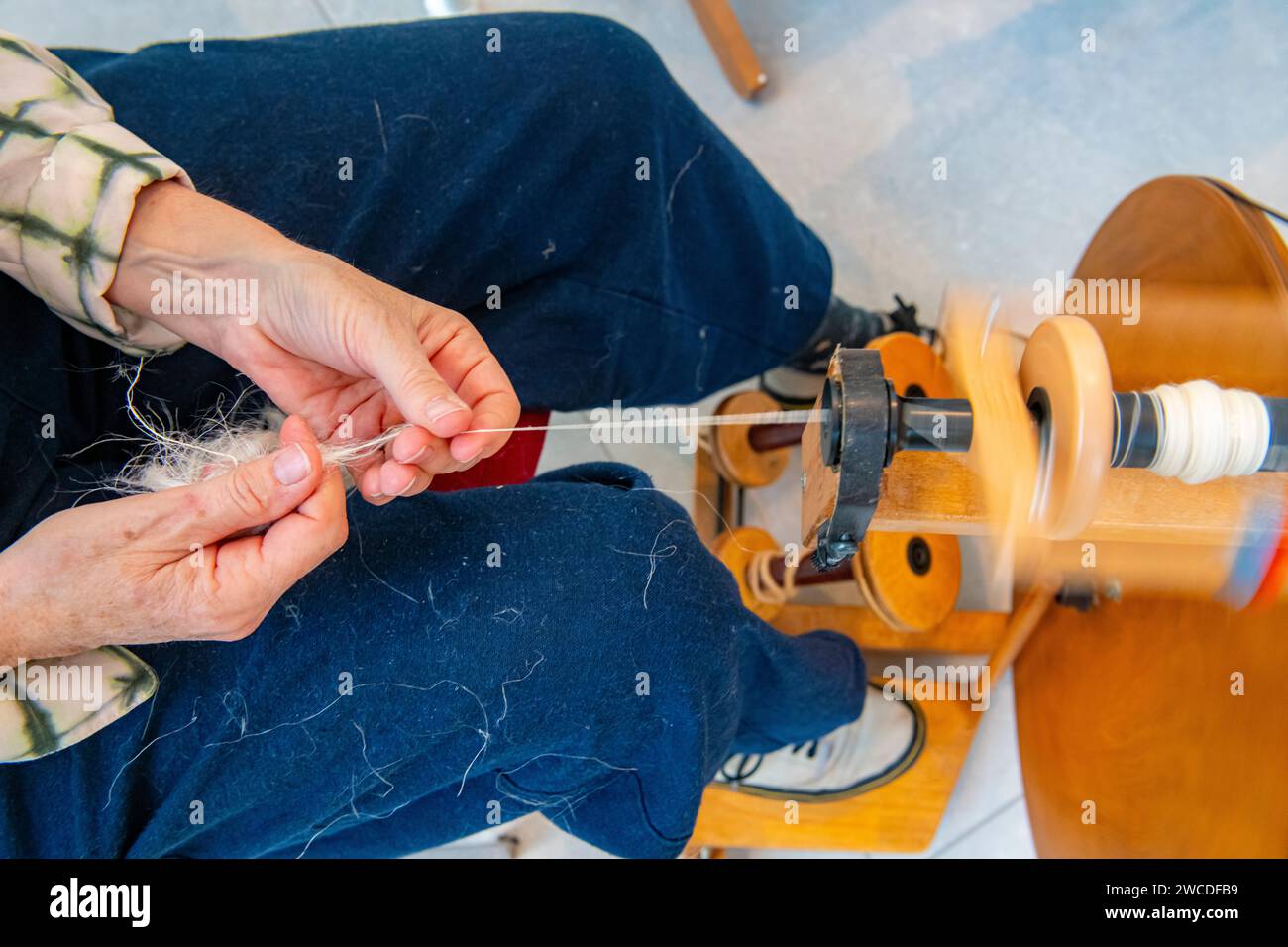 Spinning hemp with a traditional loom Stock Photo