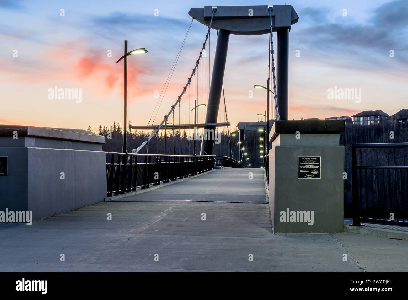 Edmonton, Canada, November  24, 2023: Fort Edmonton footbridge at sunset time with night lights turned on Stock Photo