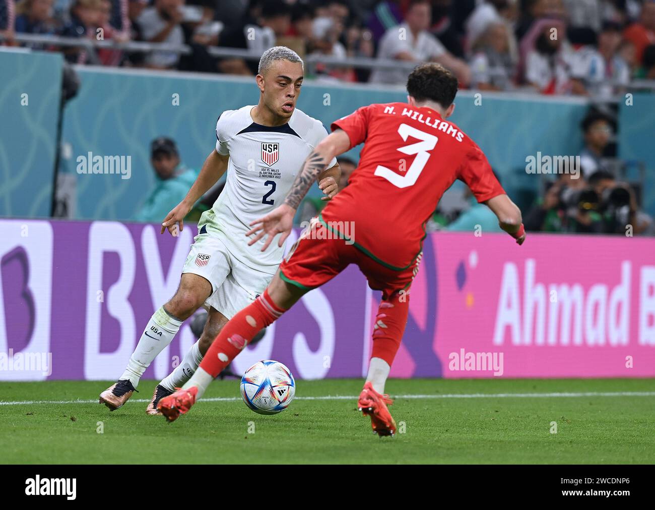 Sergio Dest of the USA Men's National Team is locked in foot-to-foot combat vs a Wales defender in the two's group stage 2022 FIFA World Cup bout. Stock Photo