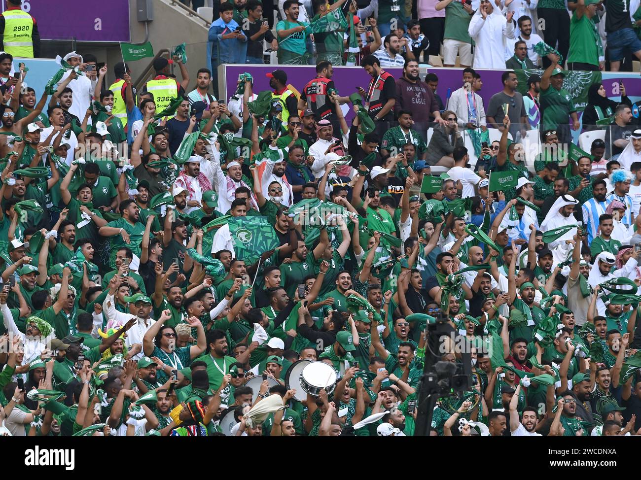 Saudi Arabian fans cheering for their team during its 2-1 group stage win versus Argentina in the opening match of the 2022 FIFA World Cup in Qatar. Stock Photo