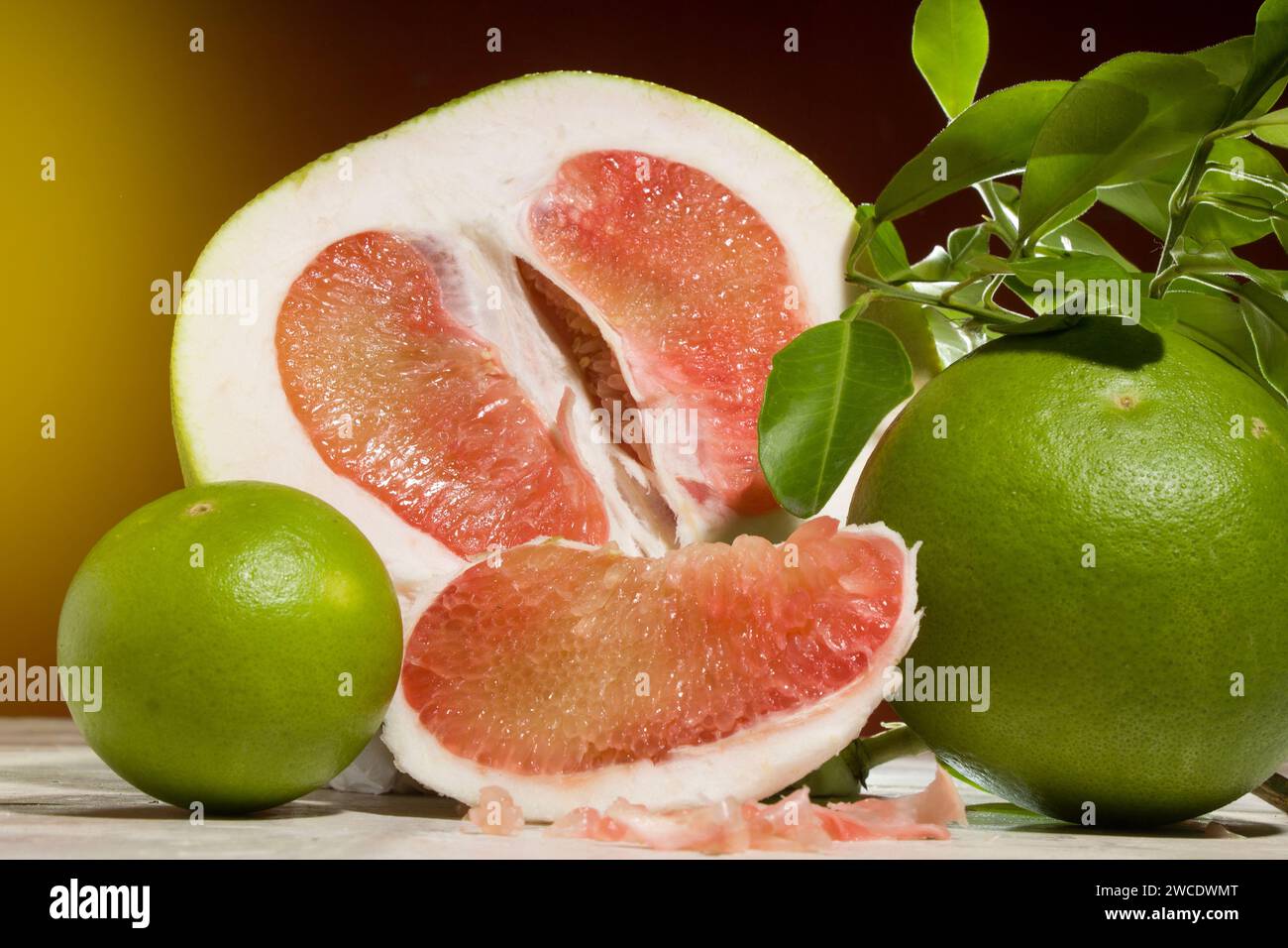 pieces of red Pomelo fruit on an orange background Stock Photo