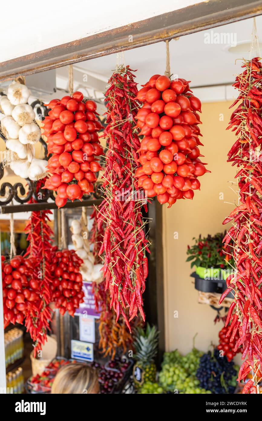 Dried Calabrian chili peppers hanging on the street market Stock Photo
