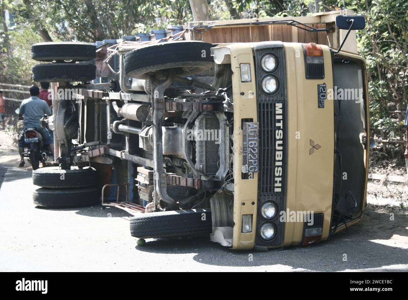 The truck overturned during an accident on a cross-city road in East Java, Indonesia Stock Photo