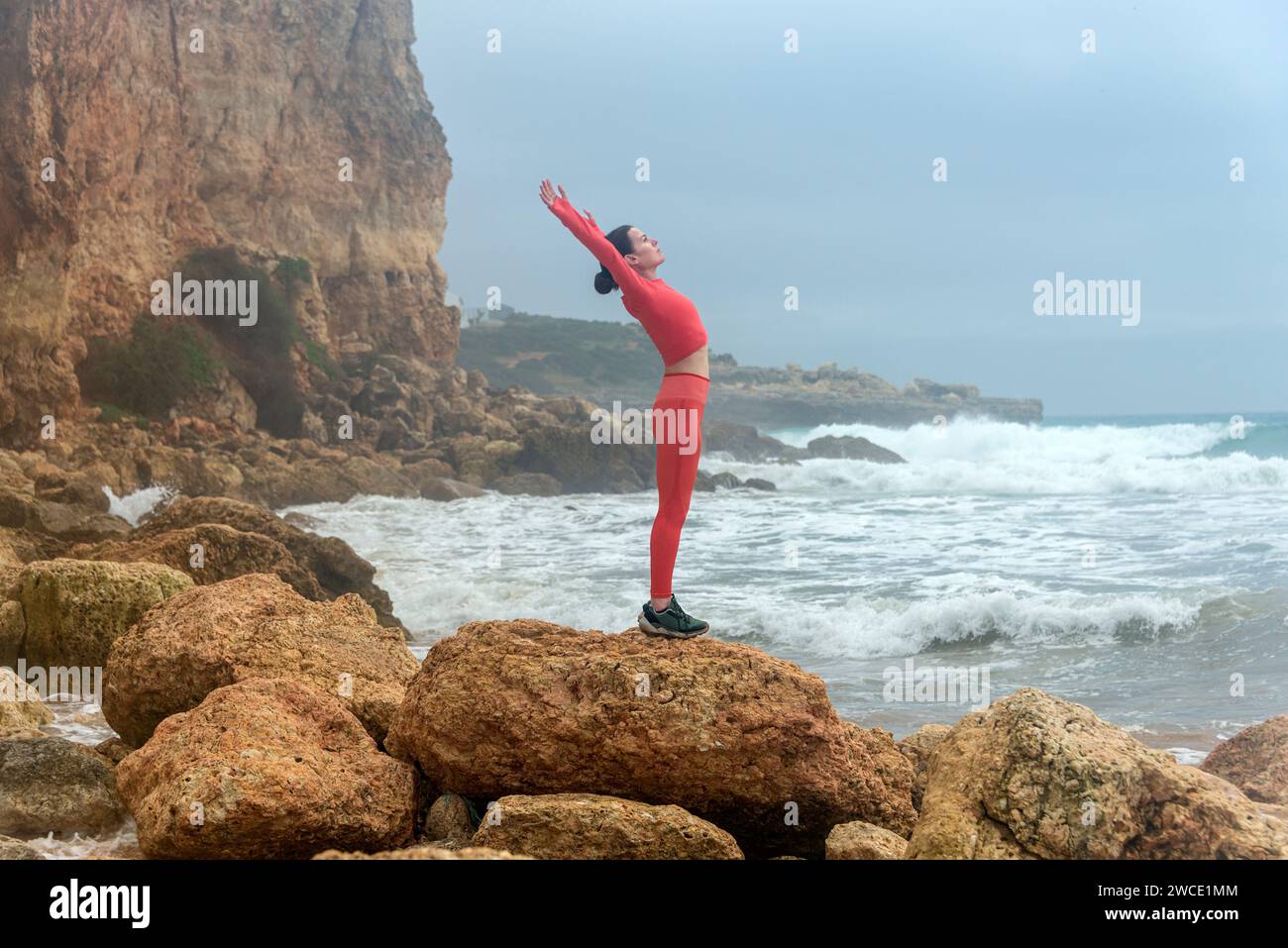 Woman standing sea raised arms hi-res stock photography and images - Alamy