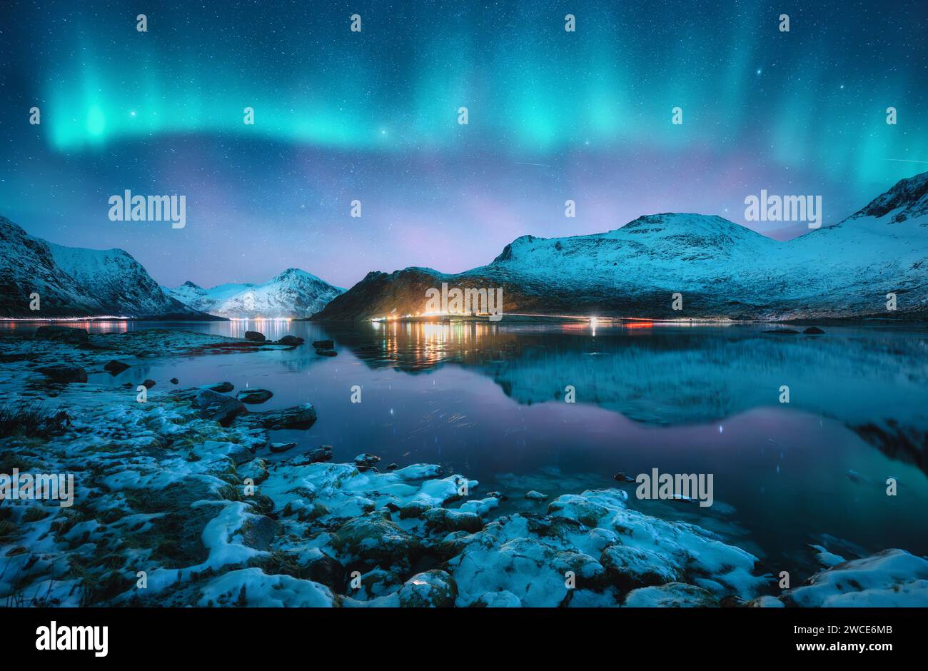 Aurora borealis, snowy mountains, frozen sea, reflection at night Stock ...