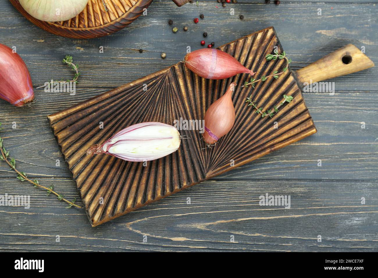 Board with shallot onion on dark wooden background Stock Photo - Alamy