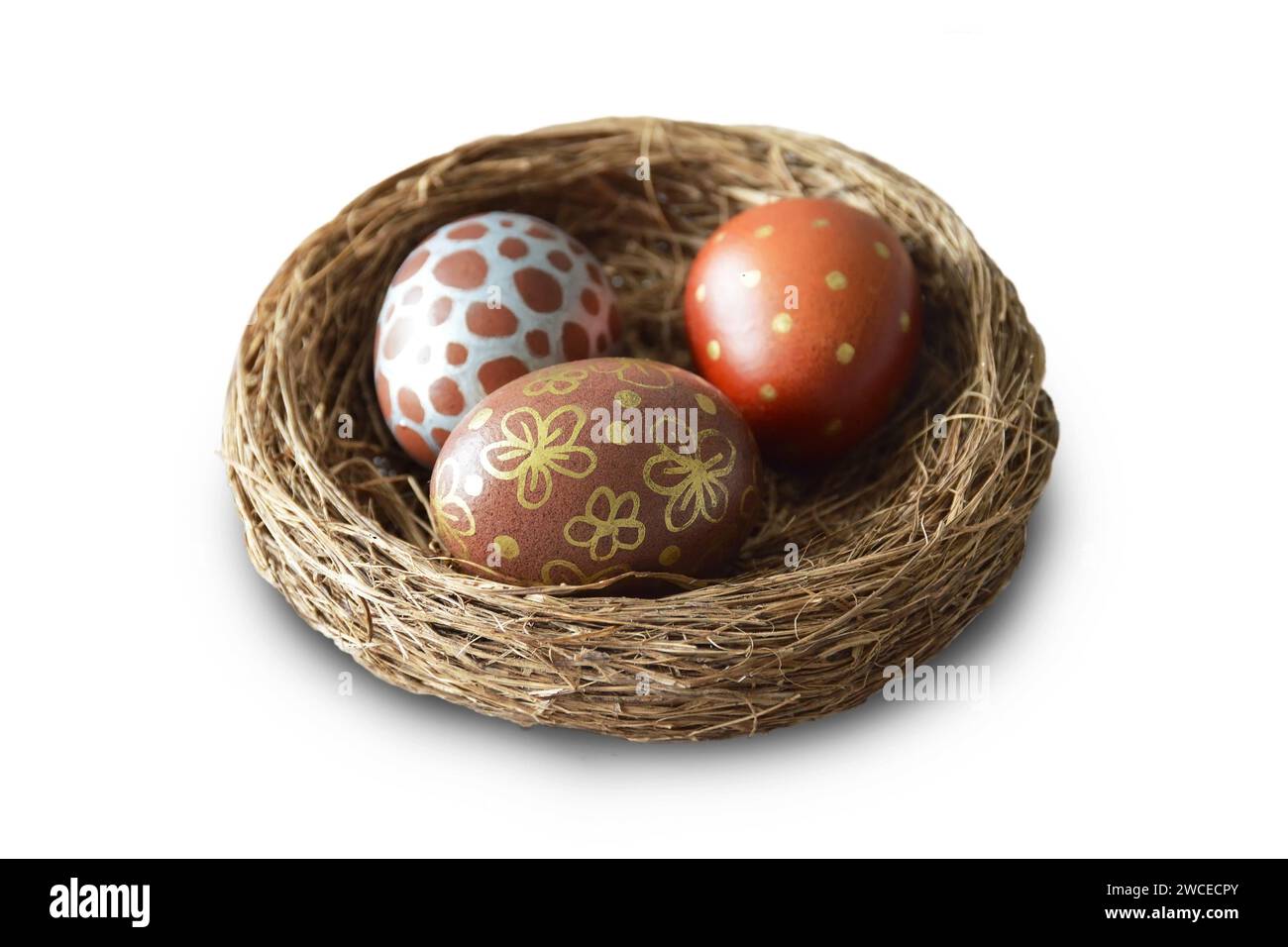 Easter eggs in nest isolated on white background Stock Photo