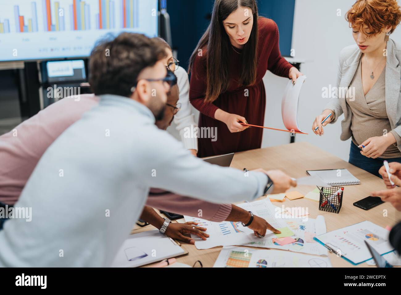 Businesspeople collaborate in an office brainstorming session for ...