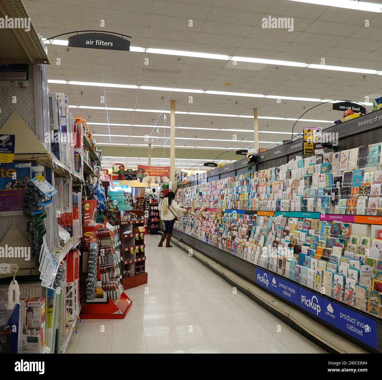 Woman shopping for a greeting card in a Kroger grocery store November