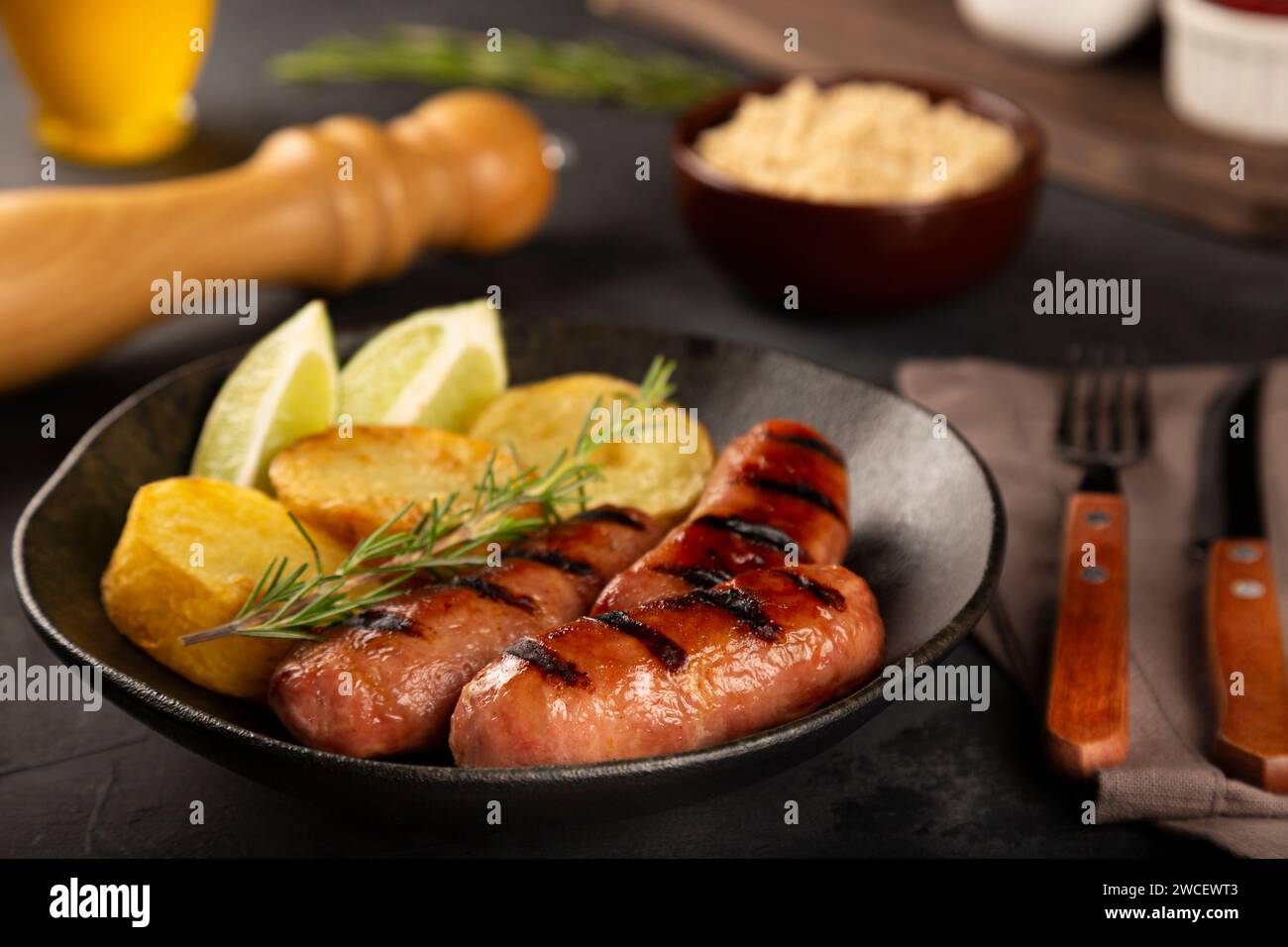 Grilled barbecue sausages on wooden background. Stock Photo
