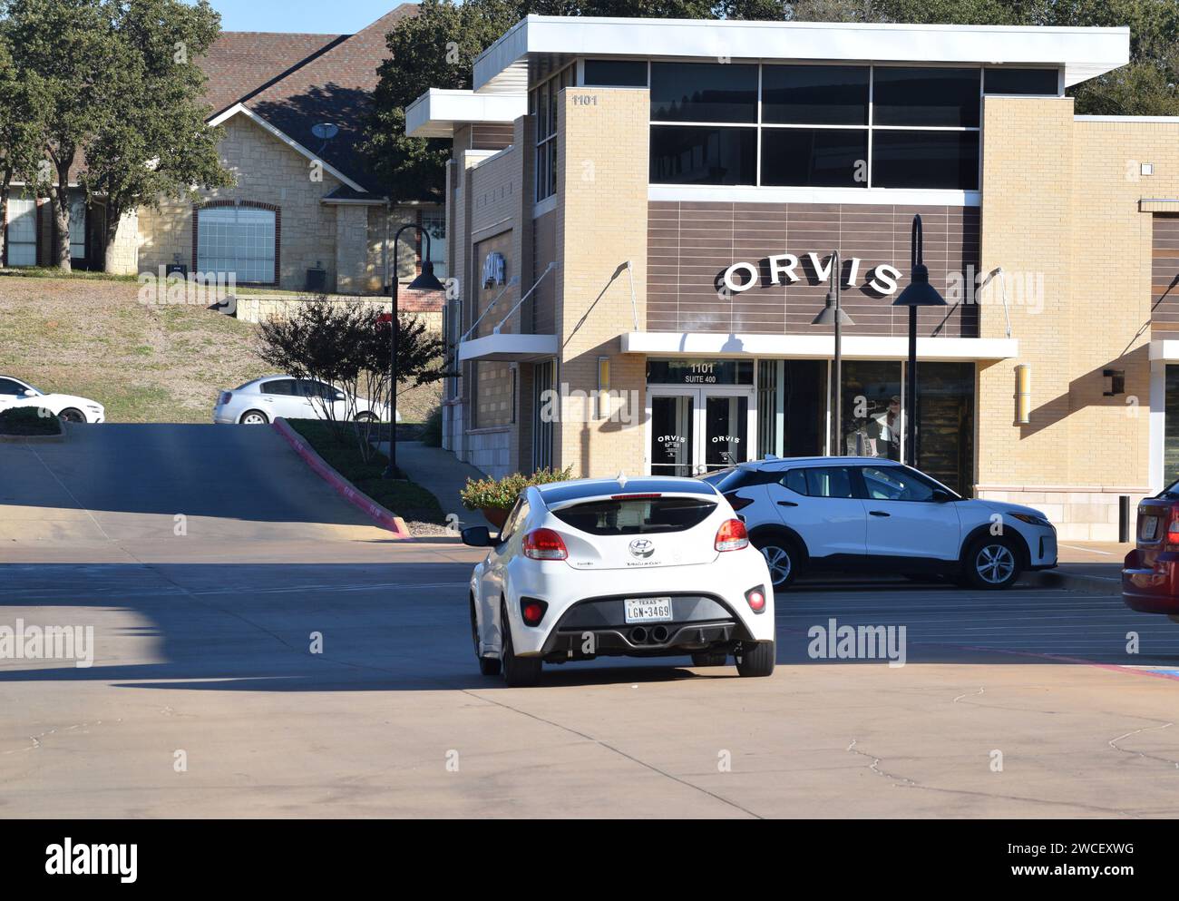 A Hyundai Veloster driving towards an Orvis store in Southlake Texas - November 2023 Stock Photo
