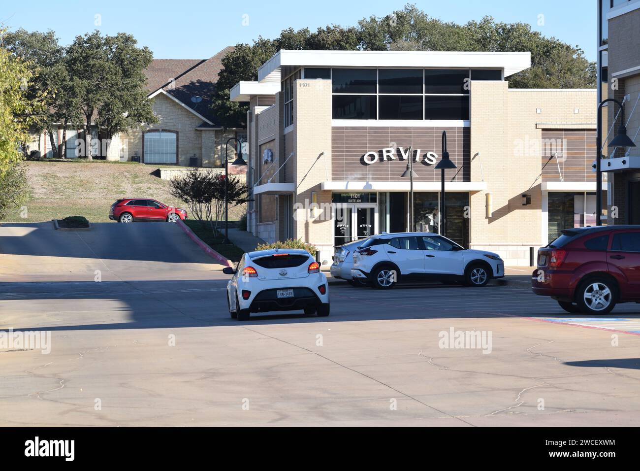 A Hyundai Veloster driving towards an Orvis store in Southlake Texas - November 2023 Stock Photo