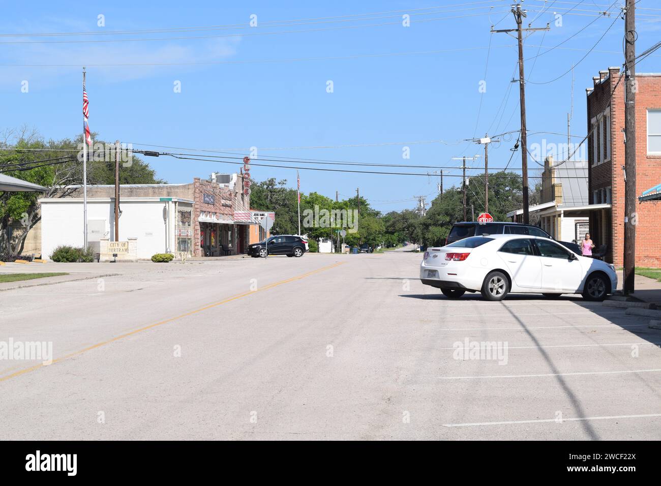 Cars parked on a sunny clear day in downtown Bertram Texas May 2023