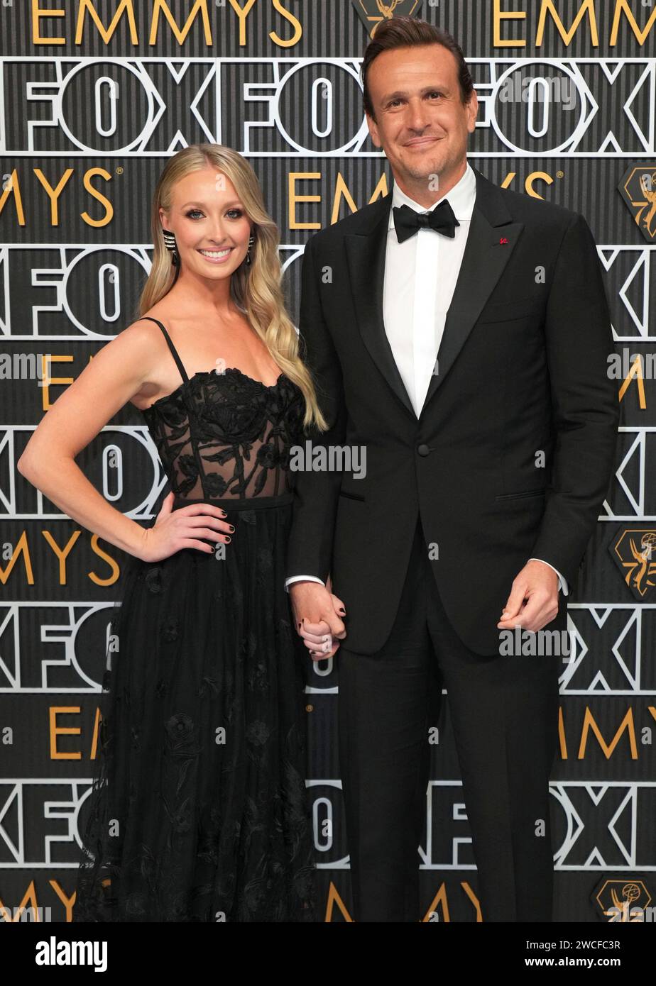 Kayla Radomski, left, and Jason Segel pose for a Red Carpet portrait at the 75th Emmy Awards on