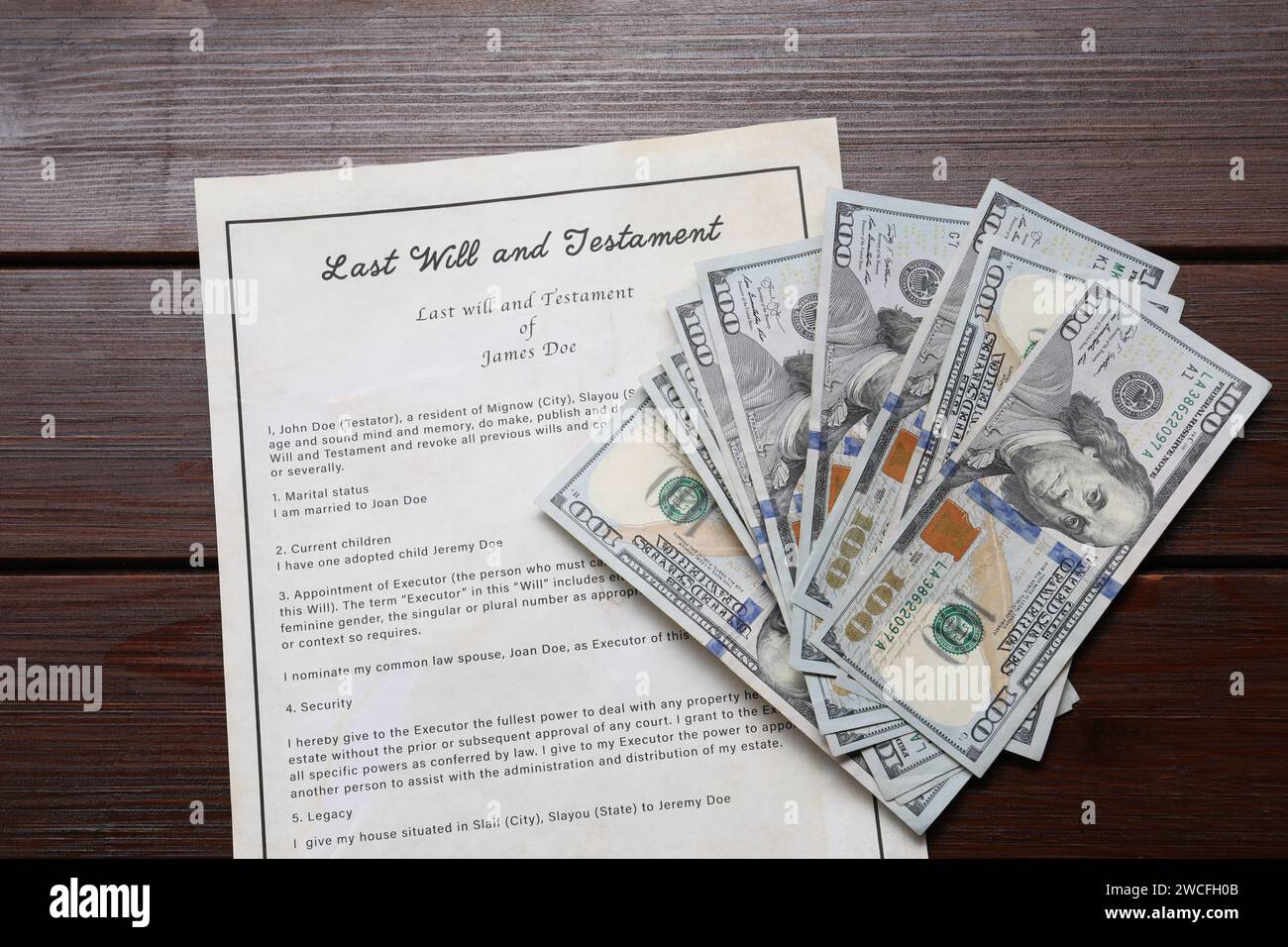 last-will-and-testament-with-dollar-bills-on-wooden-table-top-view