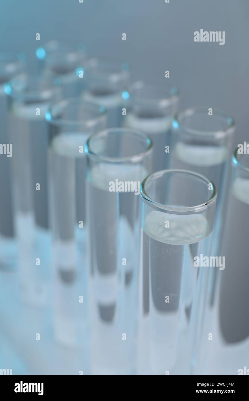 Laboratory analysis. Test tubes with liquid samples on color background ...