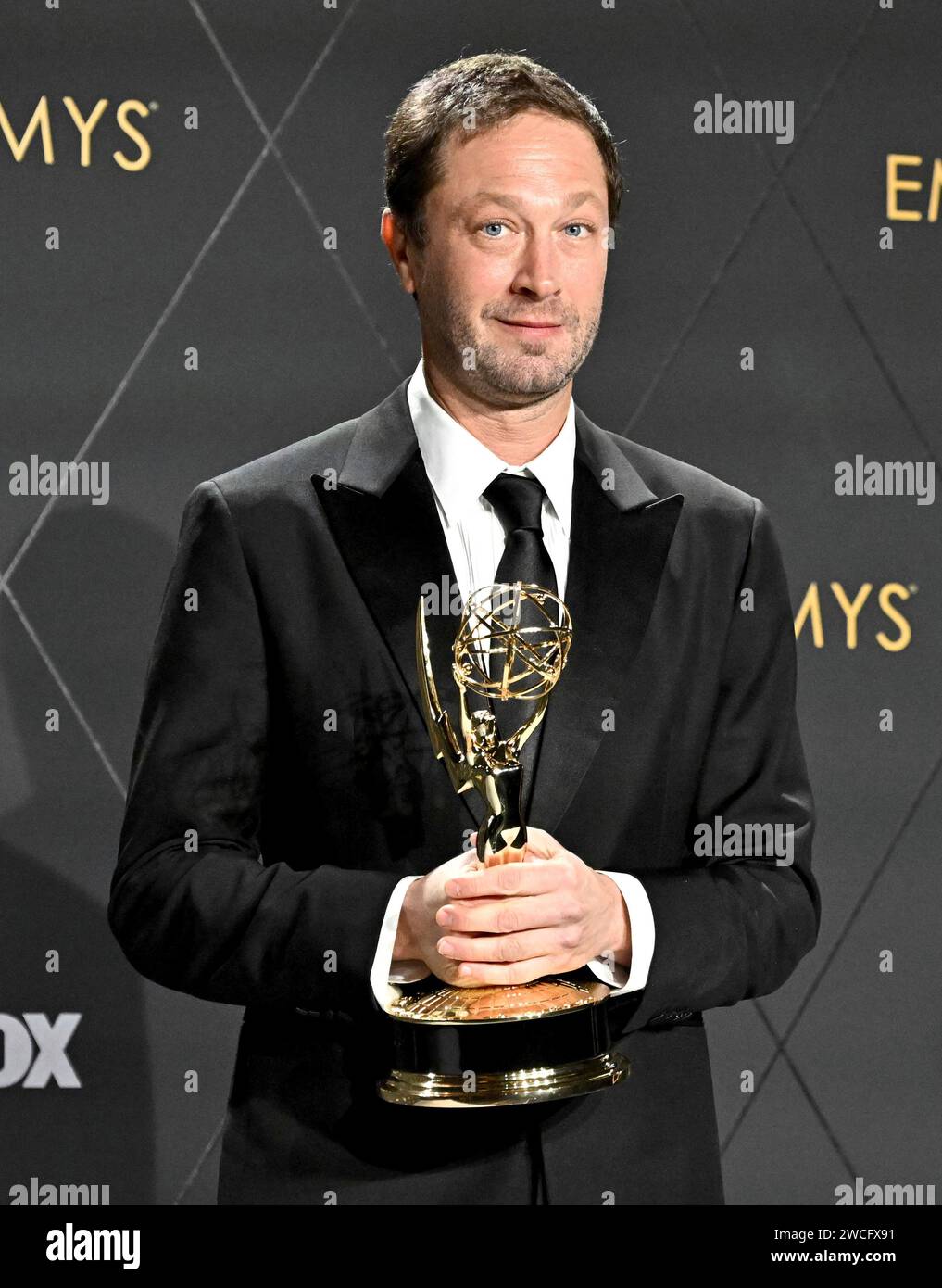 Ebon MossBachrach poses in the pressroom with the Emmy for supporting(05)
