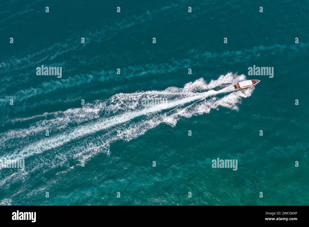 High speed boat rushing along the water surface of warm tropical waters ...