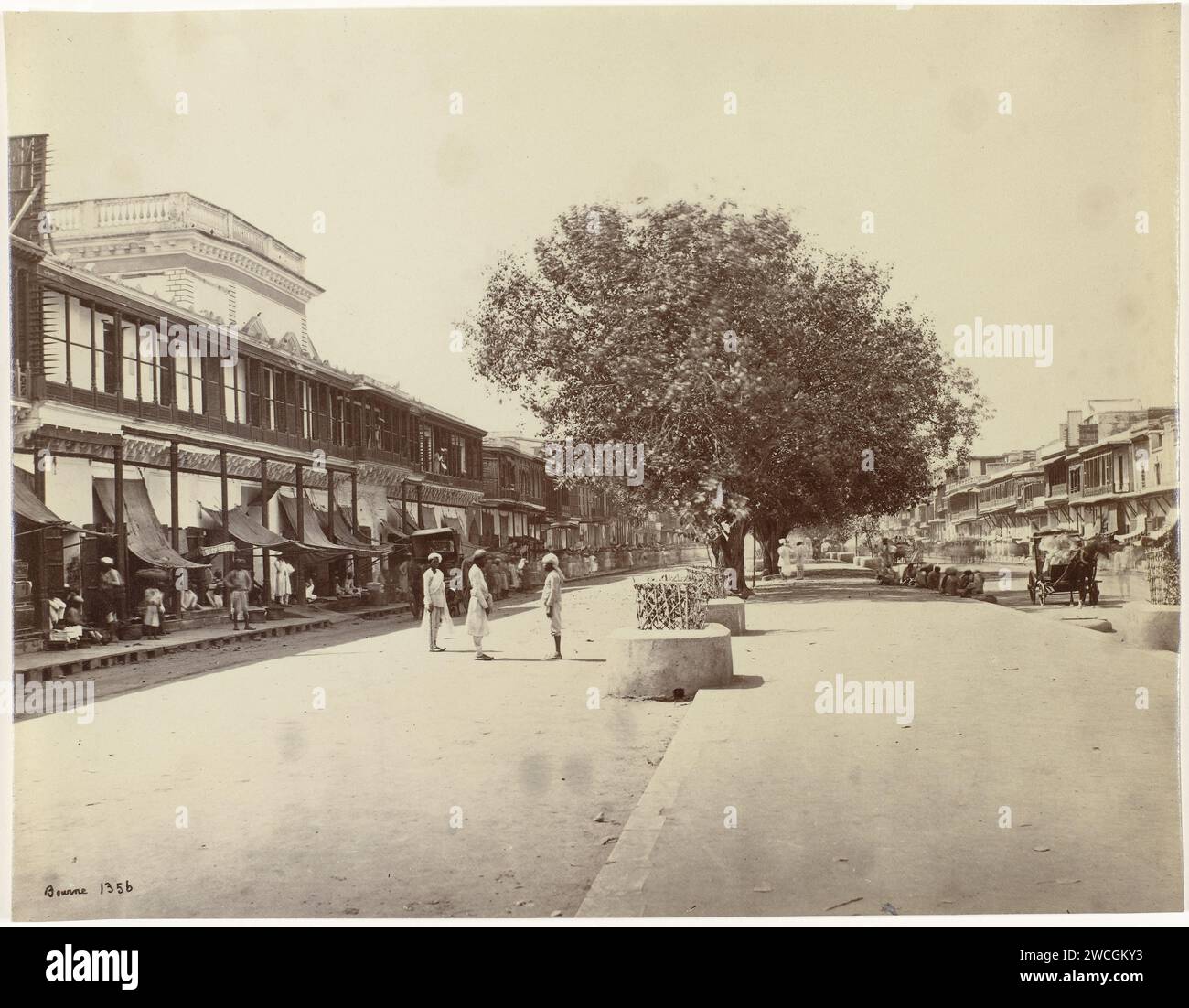 View of Chandni Chowk in Shahjahanabad, Delhi, India, Samuel Bourne, 1865 - 1870 photograph Chandni Chowk is the main street of Shahjahanabad, the last of the seven historic cities of Delhi. Along the road are shops and artisans sell their what. The street was constructed in 1650 by Jahanara Begum, the daughter of emperor Shah Jahan, and connected the city with their reinforced palace, The Red Fort. The street was 36 meters wide (40 yards) and 1.3 kilometers long (1520 yards). Originally there was a channel along the road to provide the fort with drinking water and irrigation. Between 1840 and Stock Photo