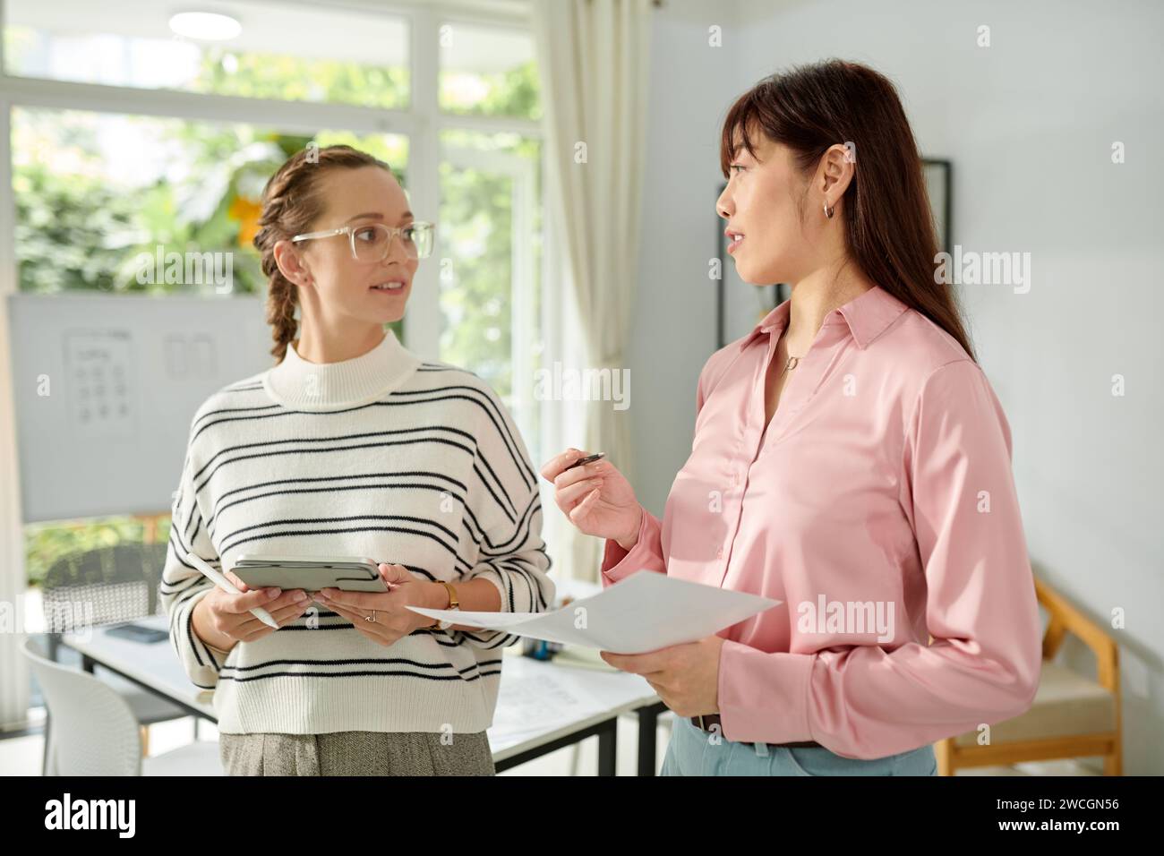 UX developer and graphic designer discussing mobile application update Stock Photo