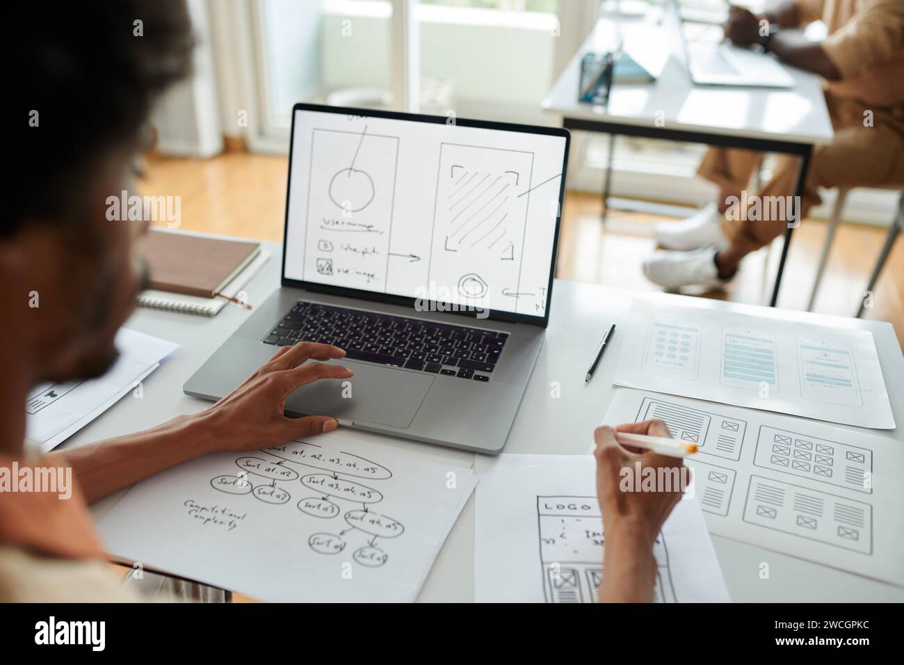 UX designer developing interface for mobile application, view over ...