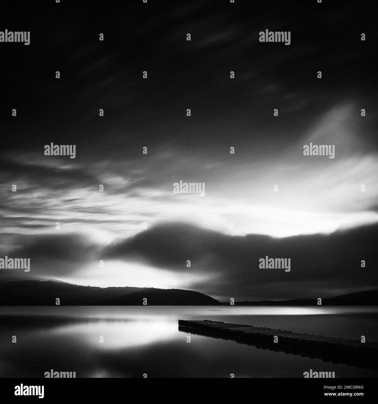 Long exposure shot of dramatic clouds over wooden jetty, lake Yamanaka, Japan Stock Photo