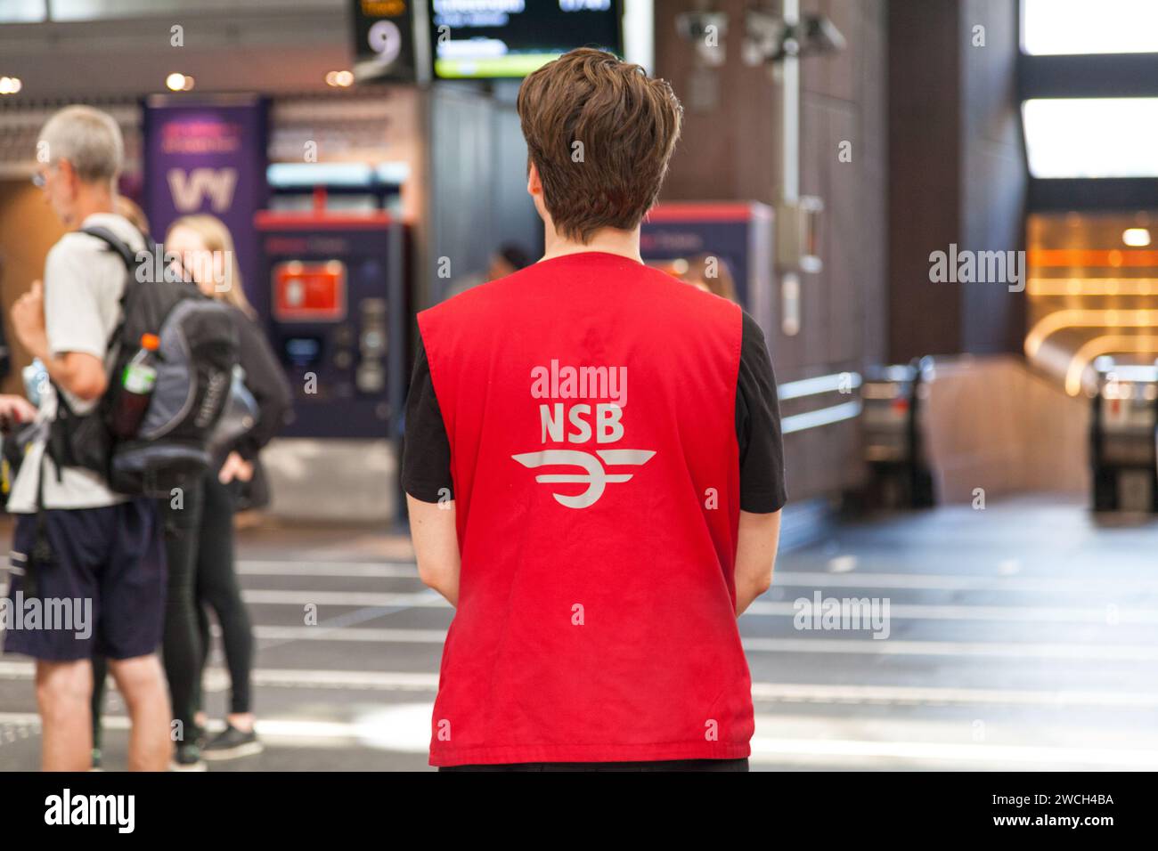 Oslo, Norway - June 26 2019: Employee of the NSB Railways waiting to assist passengers in need at Oslo Central Station. Stock Photo