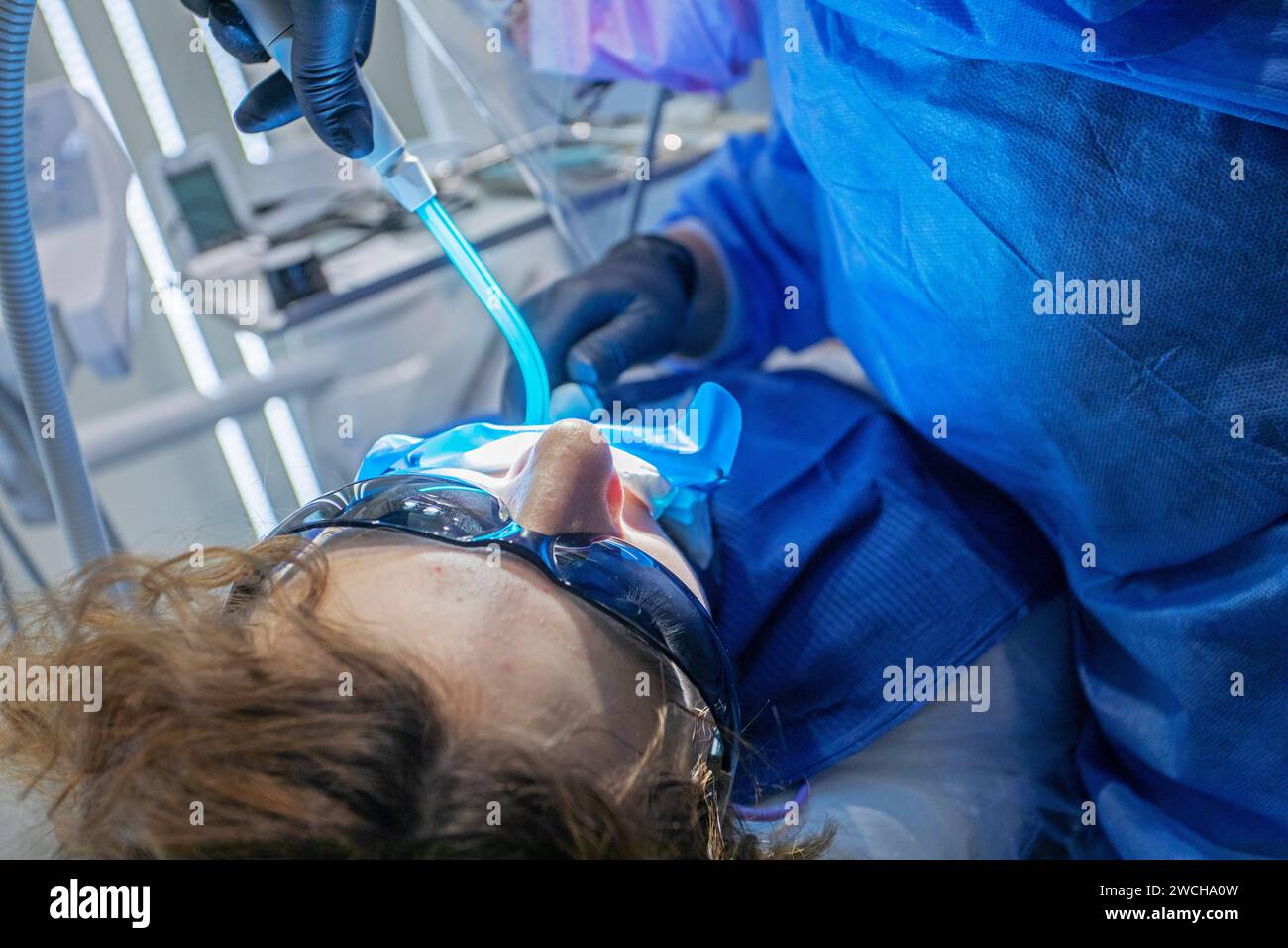 girl on the dentist's couch wearing sunglasses during dental treatment