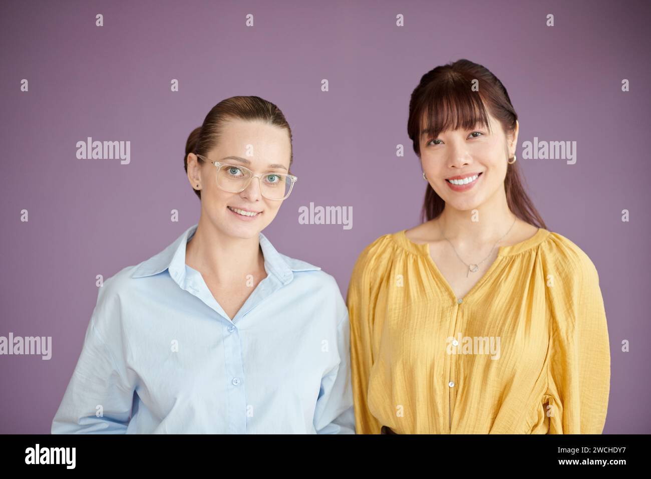 Studio portrait of female coworkers smiling at camera Stock Photo