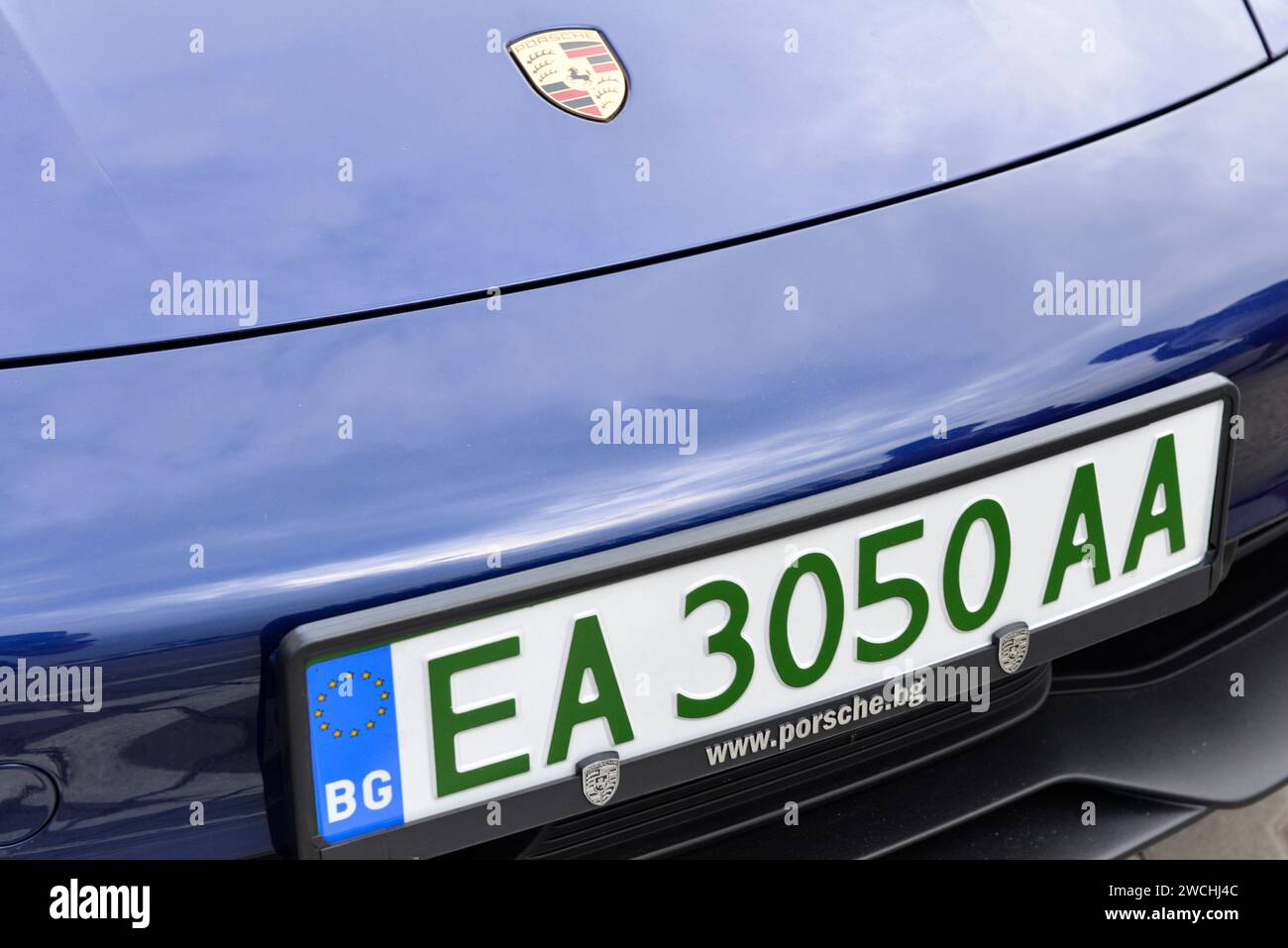 Blue electric Porsche with an EA Bulgarian license plate or registration number plate with dark