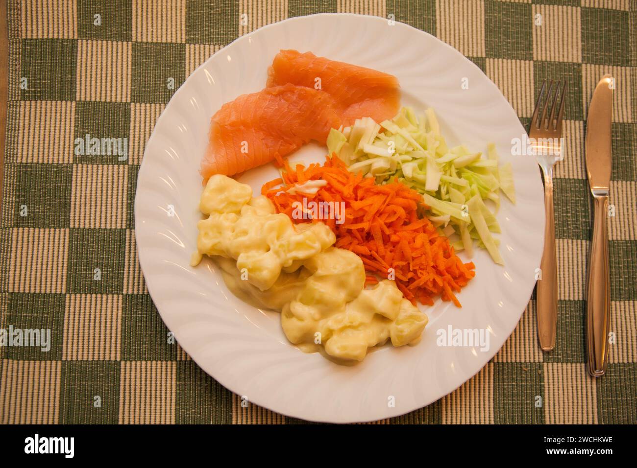 SALMON PLATE with Mustard stewed potatoes with salmon and grated cabbage and carrots Stock Photo
