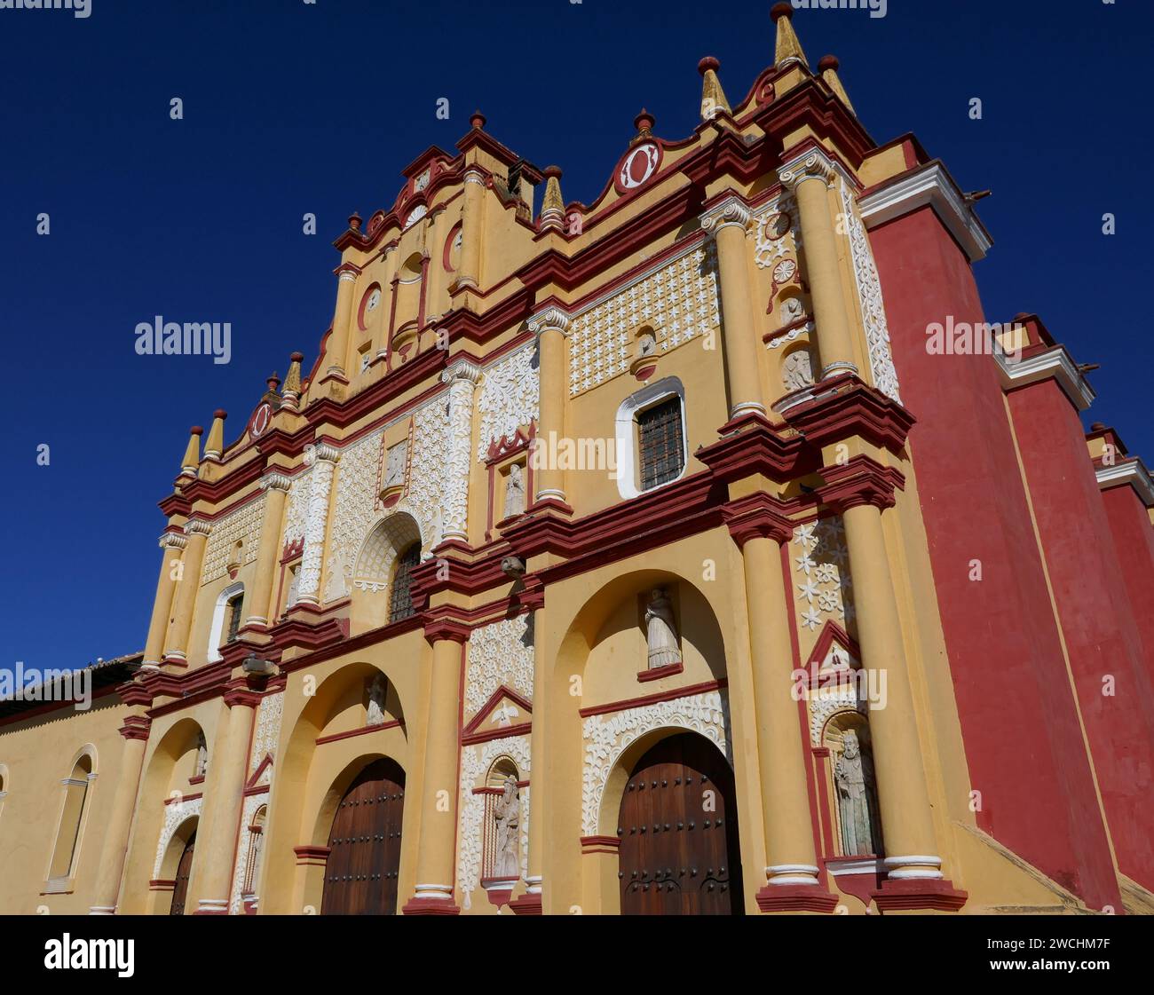Colorful baroque style church facade against a clear blue sky, San Cristobal de Las Casas, Mexico Stock Photo