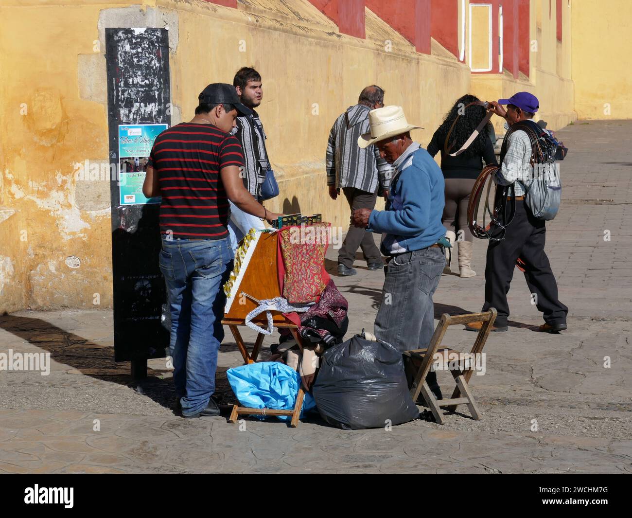 Sellers offering their wares to passerby in main square of San Cristobal de Las Casas Mexico Stock Photo