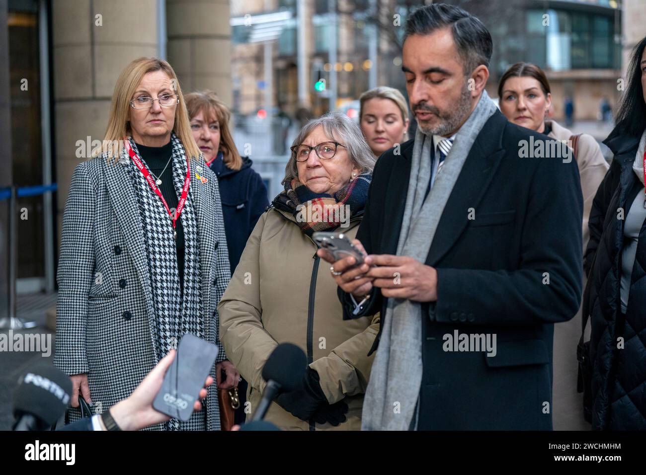 Jan Gillan (left) and Margaret Waterton (centre), members of the Scottish Covid Bereaved group, alongside solicitor Aamer Anwar as he speaks to the media ahead of the UK Covid-19 Inquiry hearing at the Edinburgh International Conference Centre (EICC). Picture date: Tuesday January 16, 2024. Stock Photo