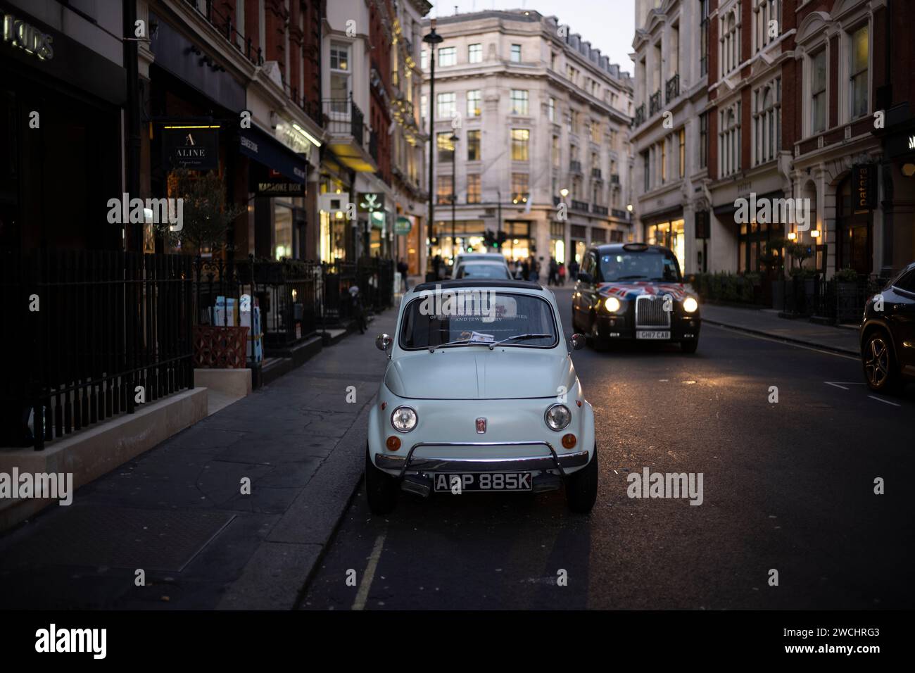 A Fiat 500 classic car is parked on Maddox Street in Mayfair looking towards Regent Street,  London, England, United Kingdom Stock Photo