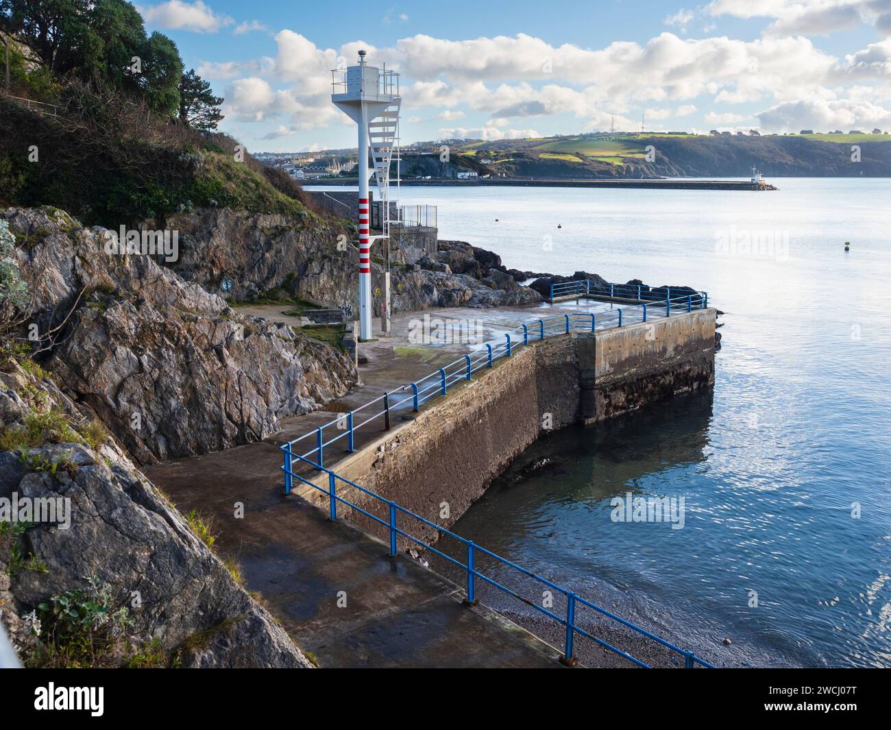 Marine navigation beacon on Plymouth Sound foreshore.  Mountbatten breakwater and Staddon Heights in background Stock Photo